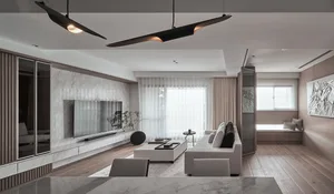 Modern living room featuring marble accents, wood flooring, and glass elements.