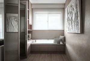 Modern bedroom featuring wooden furniture and a comfortable seating area by the window with blinds.
