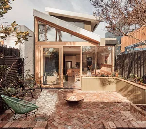 Modern architecture patio with brick herringbone pattern and fire pit.