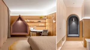 A modern bedroom featuring wood-paneled walls, a built-in shelving unit with a desk and chair, and a cozy alcove seating area