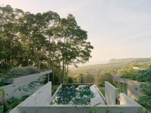 Modern concrete retreat with panoramic landscape view.