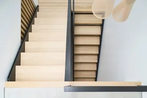 A modern-looking wooden staircase with a minimalist design.
