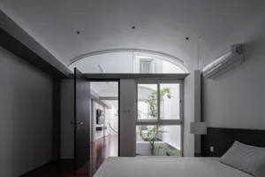 Modern minimalist bedroom featuring concrete and glass materials.