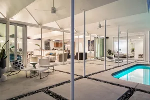 Modern residential interior design featuring white furniture and white walls.