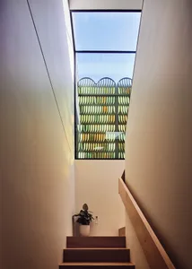 Stairwell featuring modern design with wooden steps and glass elements.