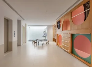 A playroom with wooden furniture and multicolored panels on the walls.
