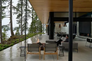 A minimalist living space with concrete and wood elements.