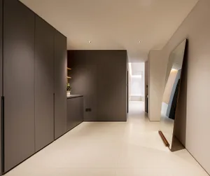 A modern entrance hall featuring concrete walls and floors, with a minimalist design.