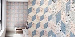 A modern interior space featuring terrazzo floor tiles arranged in a geometric pattern with a mix of colors and textures.