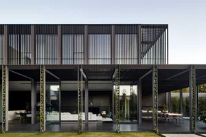 Modern building with metal overhangs, glass panels, and concrete floors.