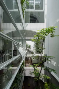 Modern interior living space featuring glass walls and concrete elements