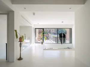 A minimalist interior design featuring a metal and glass structure.