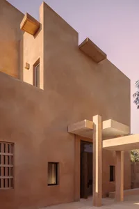 Modern exterior architecture with clay walls and minimalist design elements.