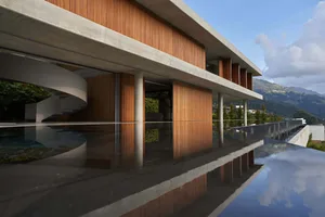 Modern house exterior featuring concrete and glass materials.