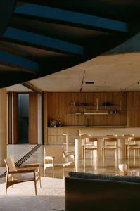 A modern residential kitchen featuring wooden furniture and a skylight.