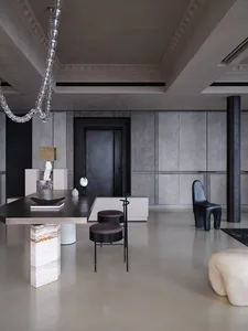 A modern living room featuring concrete and marble elements.