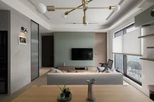 Modern living room featuring a sofa, coffee table, and minimalist decor with concrete and wood materials.