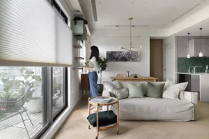 A modern living room with a neutral color palette and minimalistic design features.
