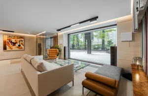 Modern living room featuring wooden and glass elements.