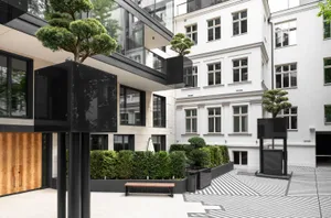 A modern living space featuring concrete and glass materials.
