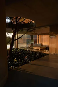A modern residential living room with minimalist design elements featuring wooden materials.