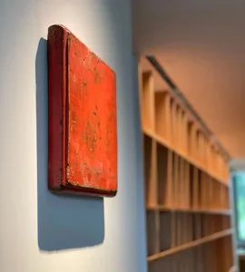 A red box mounted on a white wall in an industrial setting.