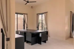 A modern minimalist office space with metallic accents and wooden furniture.