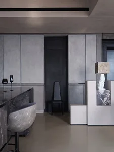 A modern interior design featuring marble and metal finishes.