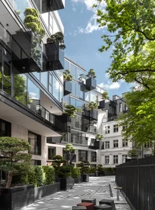 Modern residential building with glass and concrete materials.