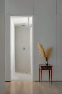 Modern minimalist bathroom with white tiled walls and floor