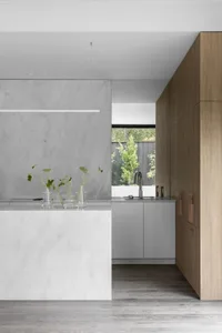 Modern residential kitchen with marble countertops and oak cabinets