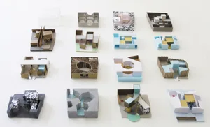 Various architecture models made of cardboard.