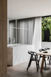 Minimalist living space featuring marble and wood elements.