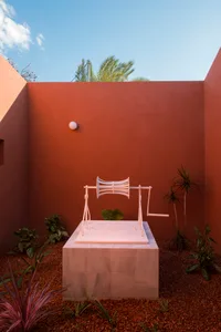 A minimalistic garden with concrete plant beds and assorted tropical plants.