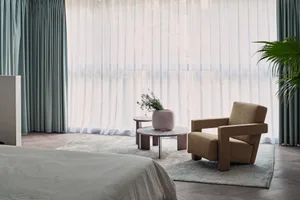 A stylish modern bedroom with luxury furnishings and minimalistic decor.
