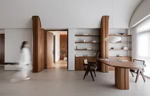 A modern home office featuring wooden furniture and shelves.