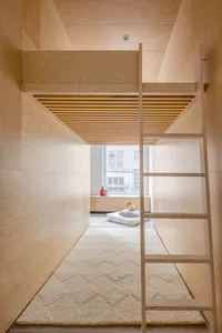 Modern interior bedroom with wooden bunk bed and cozy floor cushions