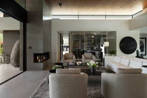 Modern living room featuring stone, concrete, and wood materials.