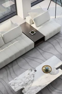 A modern minimalistic living room featuring leather furniture and marble tables.