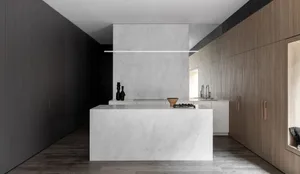 Modern residential kitchen featuring a minimalist design with a white marble countertop and backsplash.