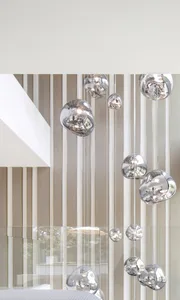 Multiple metallic hanging light fixtures in a contemporary residential interior.