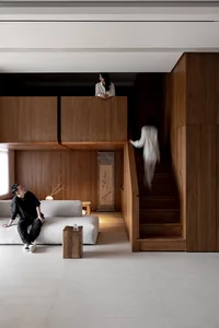 A modern living room with wooden walls and a white sofa.