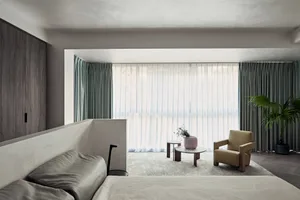 A minimalist bedroom featuring curtains, hardwood flooring, and a tranquil color palette.