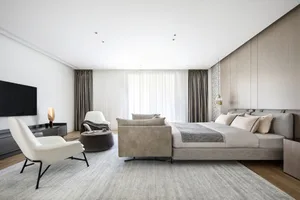 Modern minimalist bedroom featuring taupe leather furniture and beige curtains.