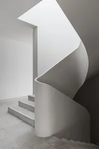 Modern interior with concrete stairs and walls.