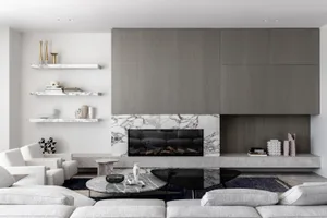 A modern, minimalist living room with marble, concrete, and wood elements.