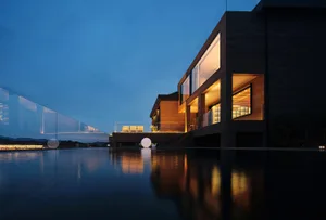 Modern residential exterior with large glass windows and illuminated interior.