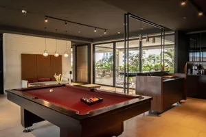 Modern living room with concrete walls, natural light, and a sleek design.