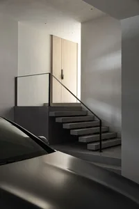 Modern interior design featuring concrete stairs and minimalist aesthetics.