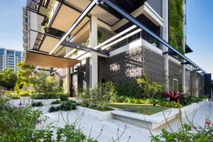 A modern apartment building with concrete, glass, and metallic exterior materials.